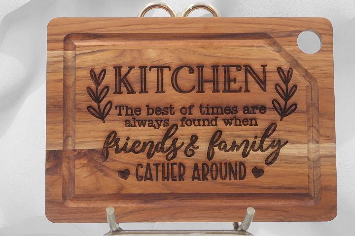 Wooden cutting board with engraved text on a stand